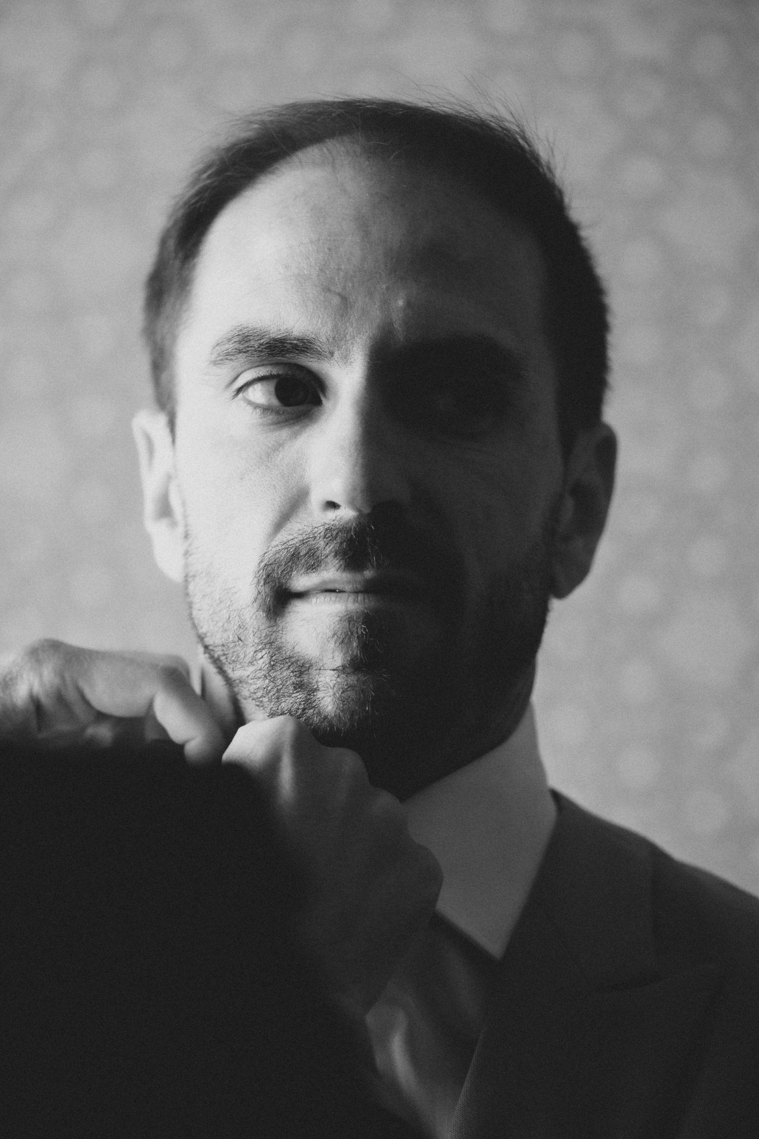 Black and white artistic portrait series showing different angles and expressions in dramatic lighting.