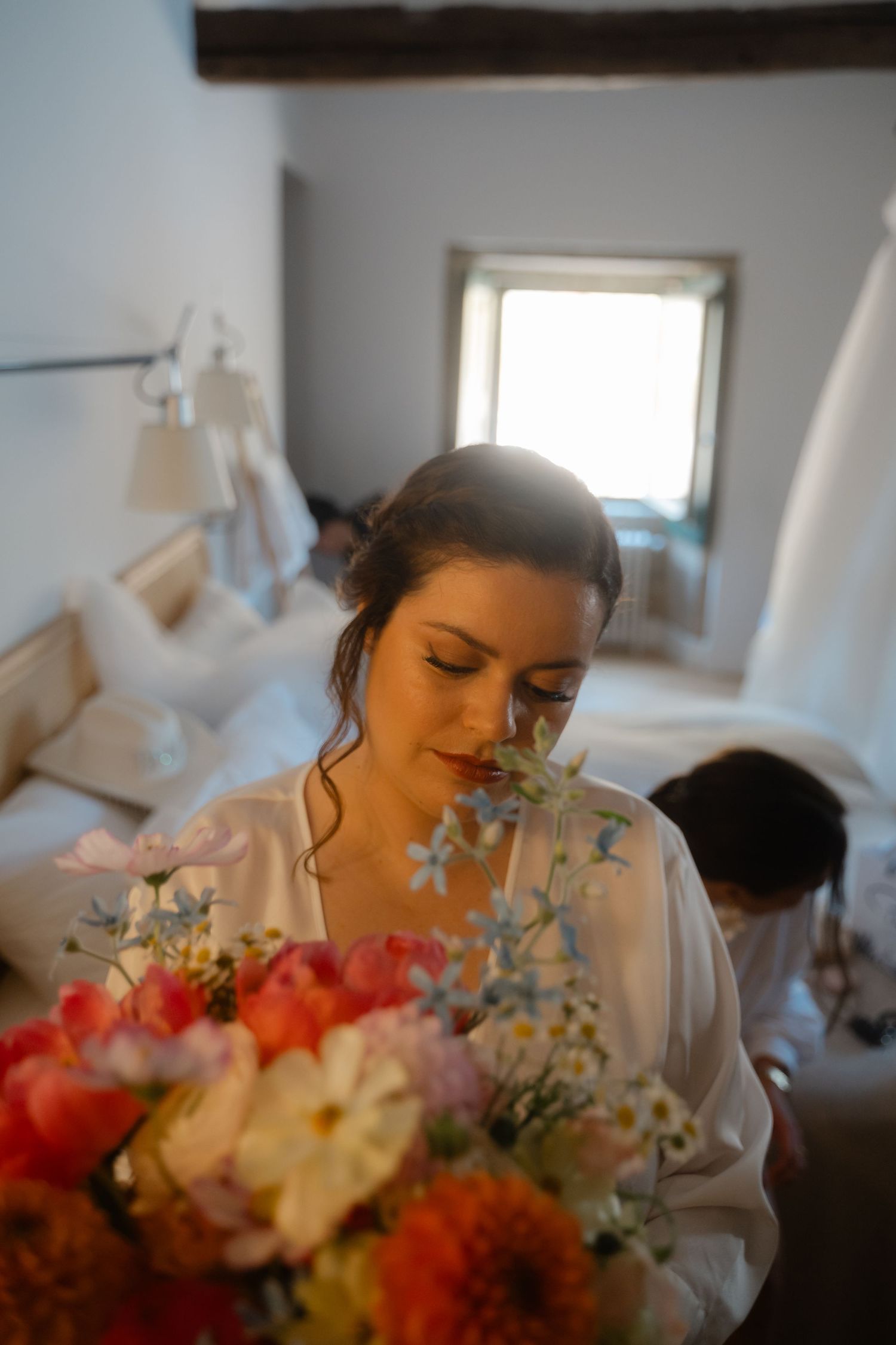 Soft focus images showing someone preparing for a special occasion with colorful floral arrangements in the foreground.