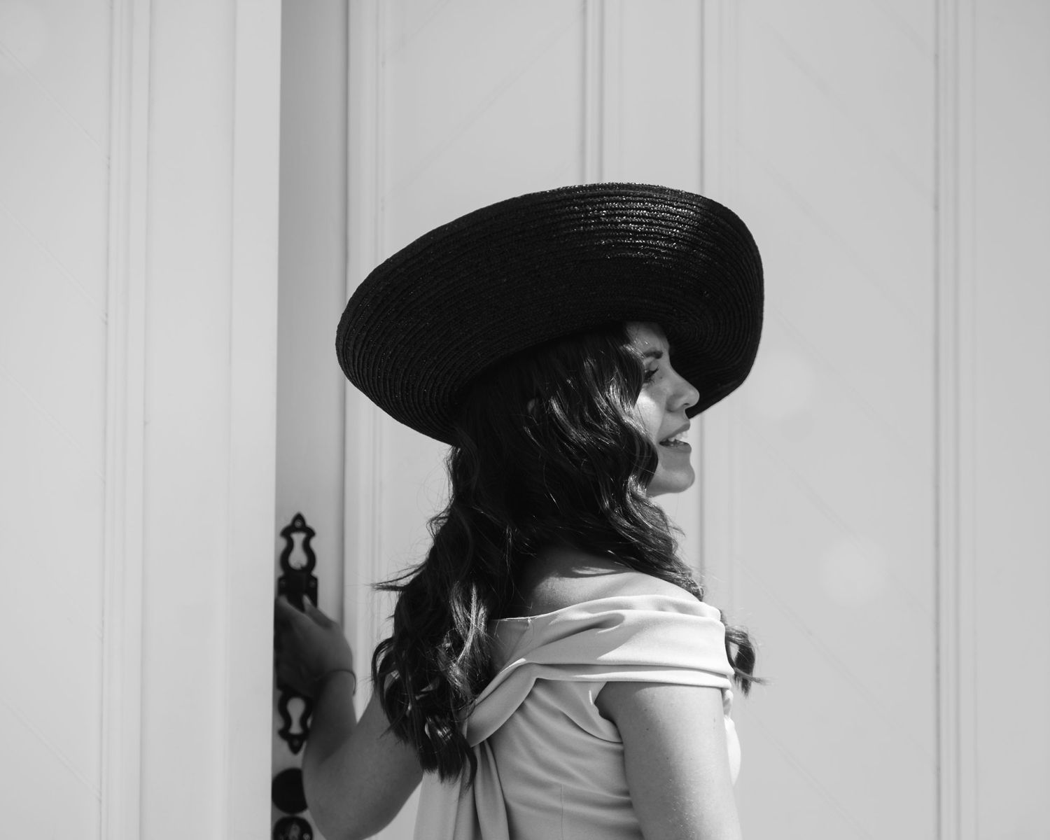 Black and white photo of elegant wedding dresses displayed on hangers.
