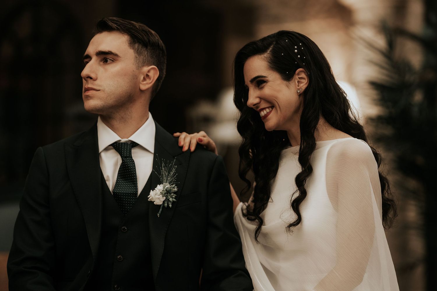 A romantic wedding couple shares intimate moments in formal attire during their special day.