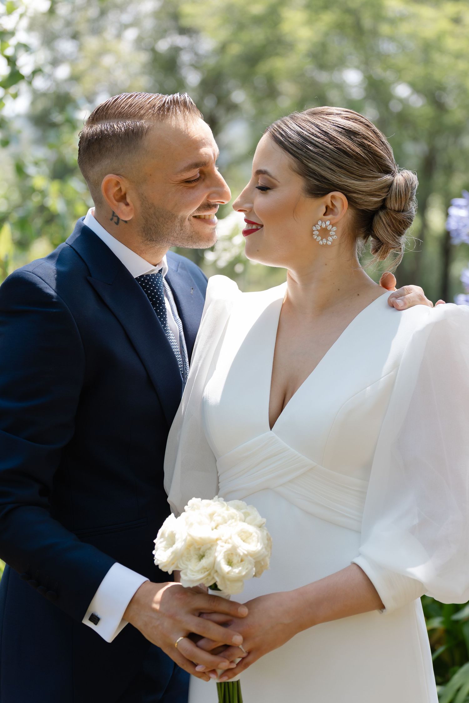 Intimate wedding portraits showing tender moments between newlyweds in classic white and navy attire.