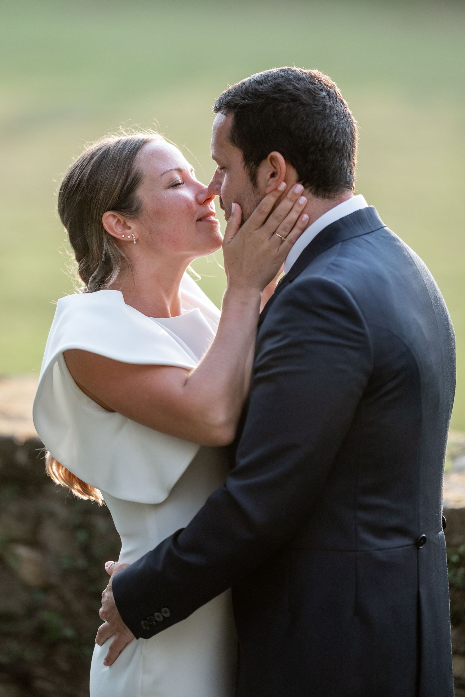 A romantic wedding kiss sequence showing four progressive moments of a couple sharing their first kiss as newlyweds.