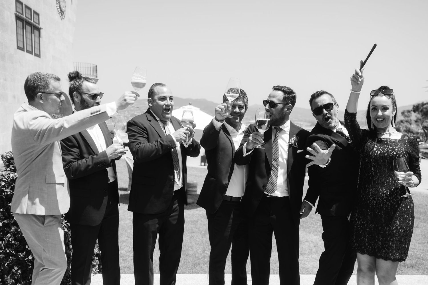A black and white photo sequence shows groomsmen in suits looking up and reacting with excitement and laughter.