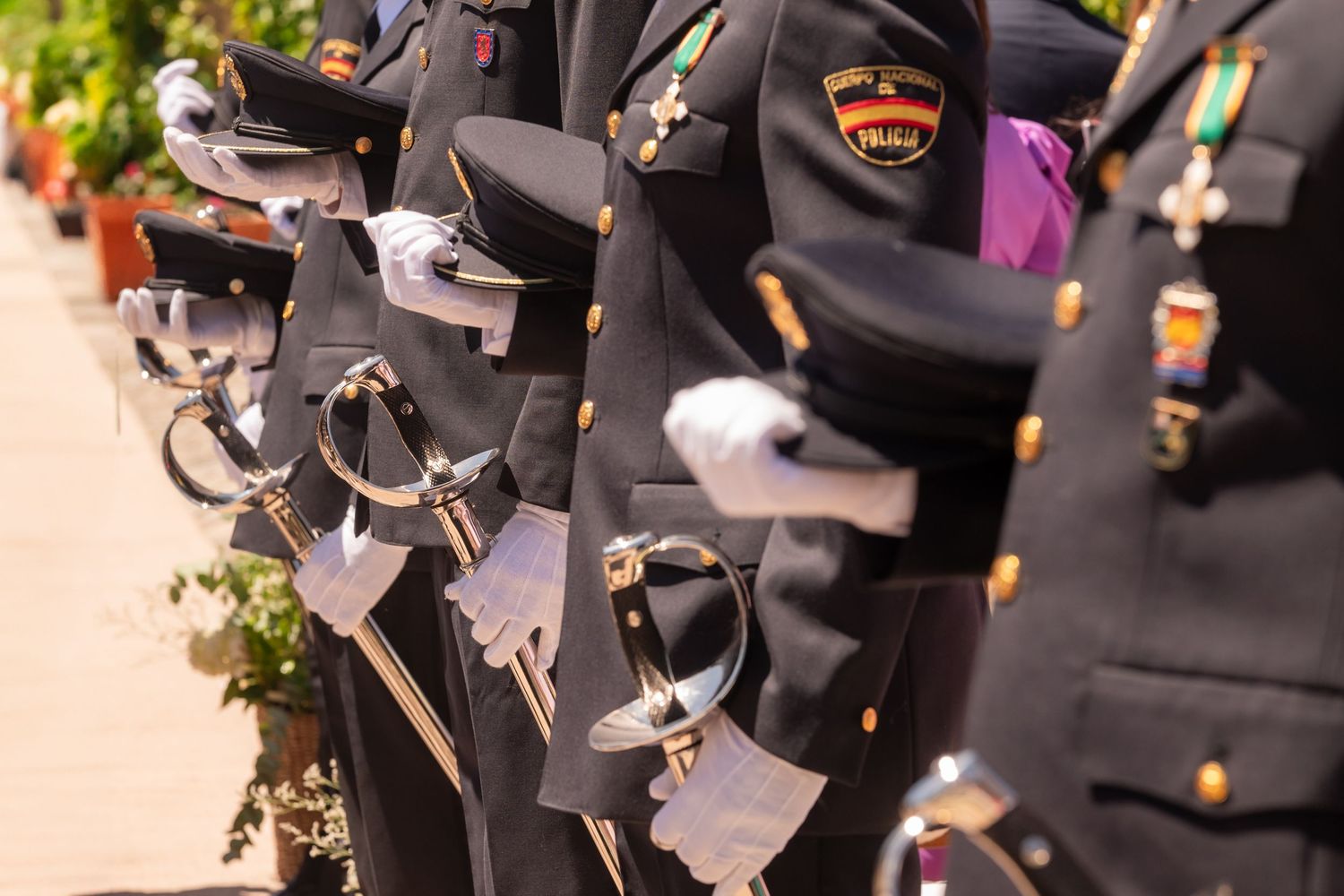 A collection of dark gray graduation caps and tassels arranged in a row against a blurred background.
