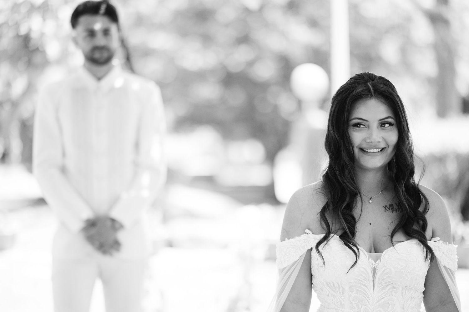 Professional black and white headshots of business team members smiling against light backgrounds.