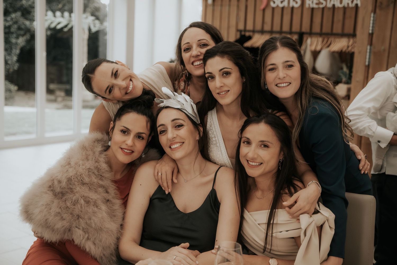 A group of friends gather together smiling and laughing during a social celebration event.
