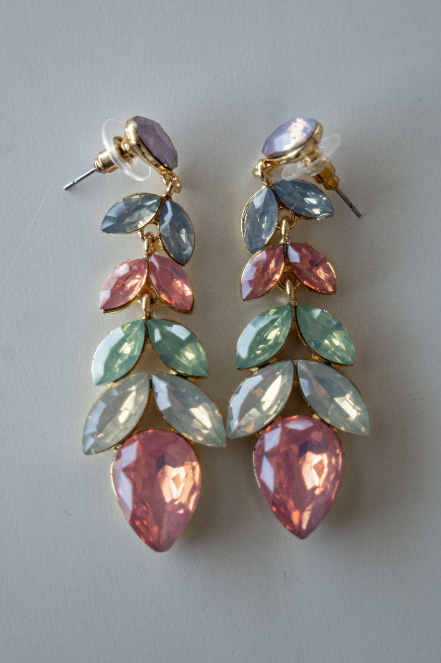 Vintage clip-on earrings featuring pastel blue, pink and mint green crystal leaves in a gold-tone setting.