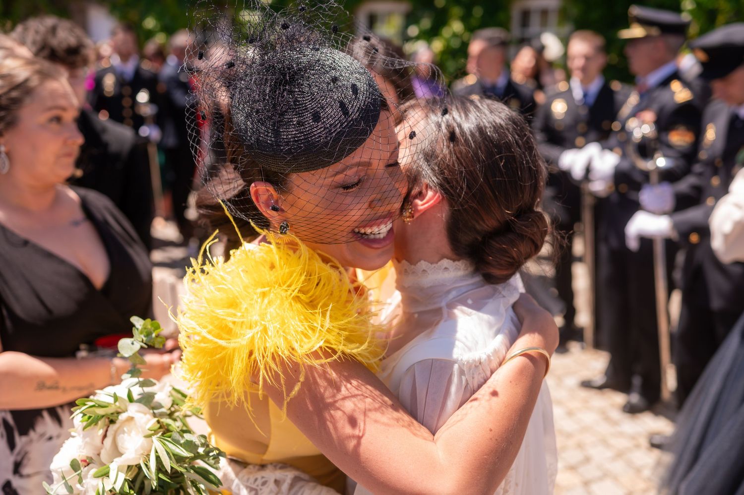 Wedding celebration with yellow floral decorations in sunny outdoor garden setting.