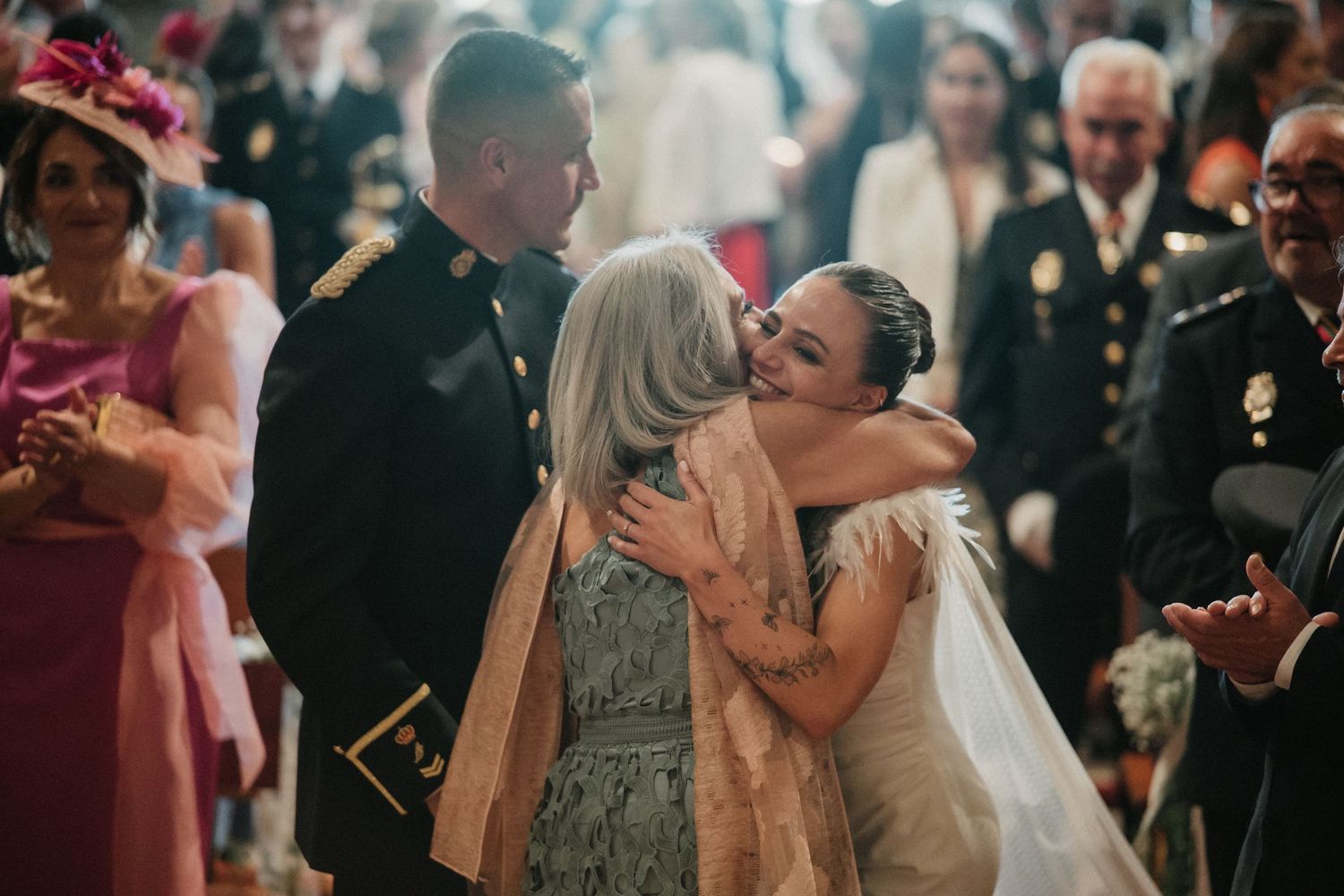 Wedding guests dancing and celebrating together at an indoor reception venue.