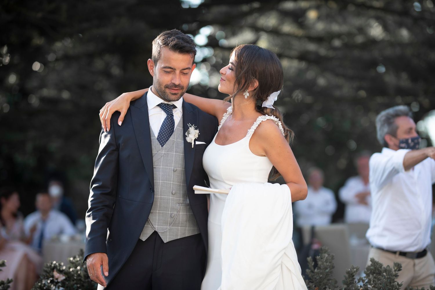 Romantic dance sequence between newlyweds at an outdoor wedding celebration.