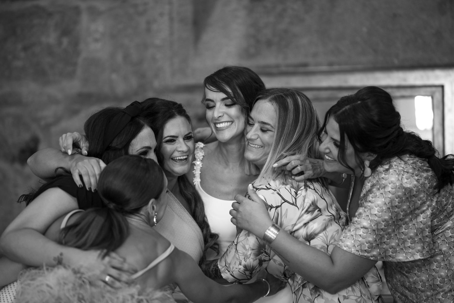 A series of black and white photos showing people embracing in emotional moments.