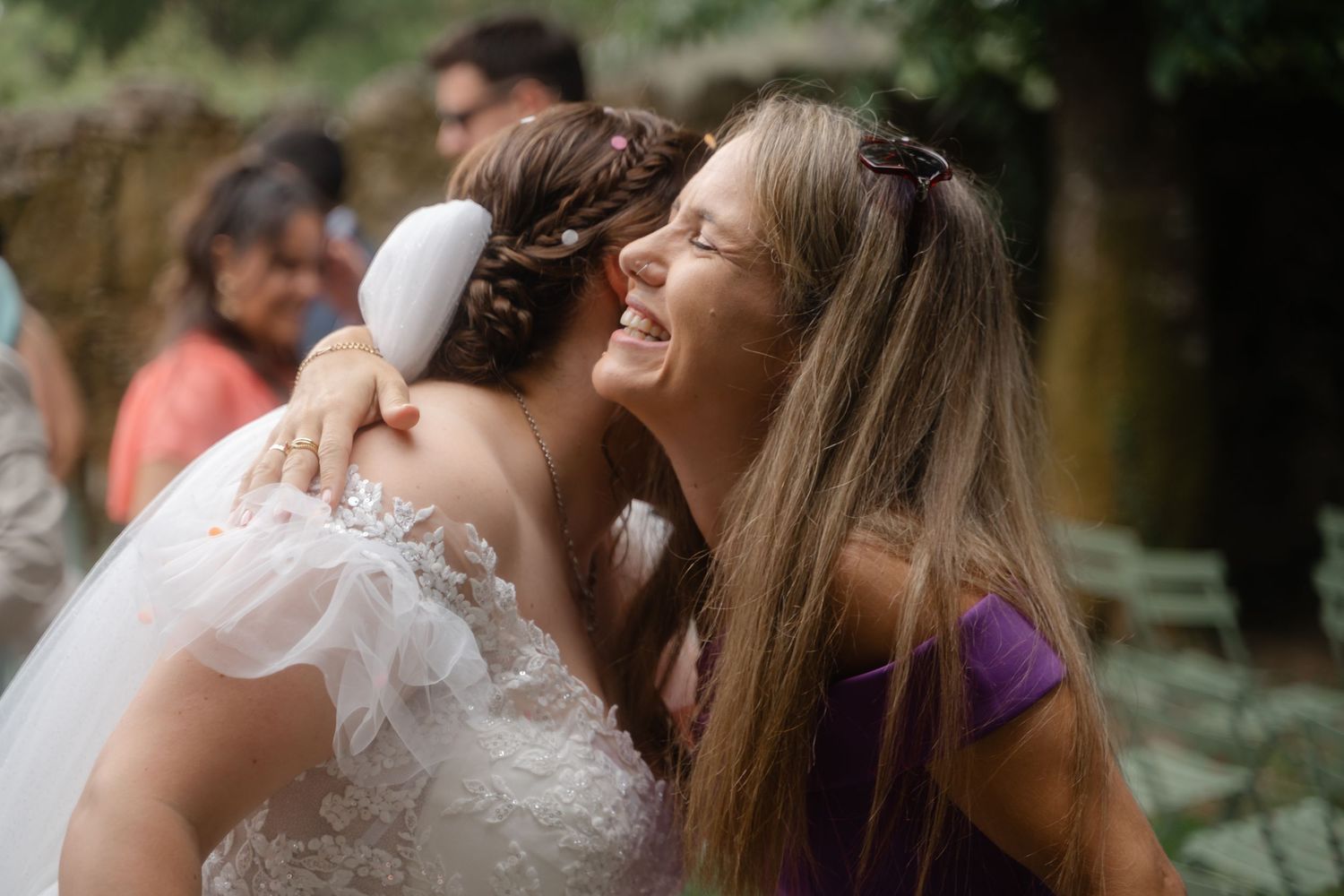 Close-up view of guests enjoying a wedding celebration in a garden setting.