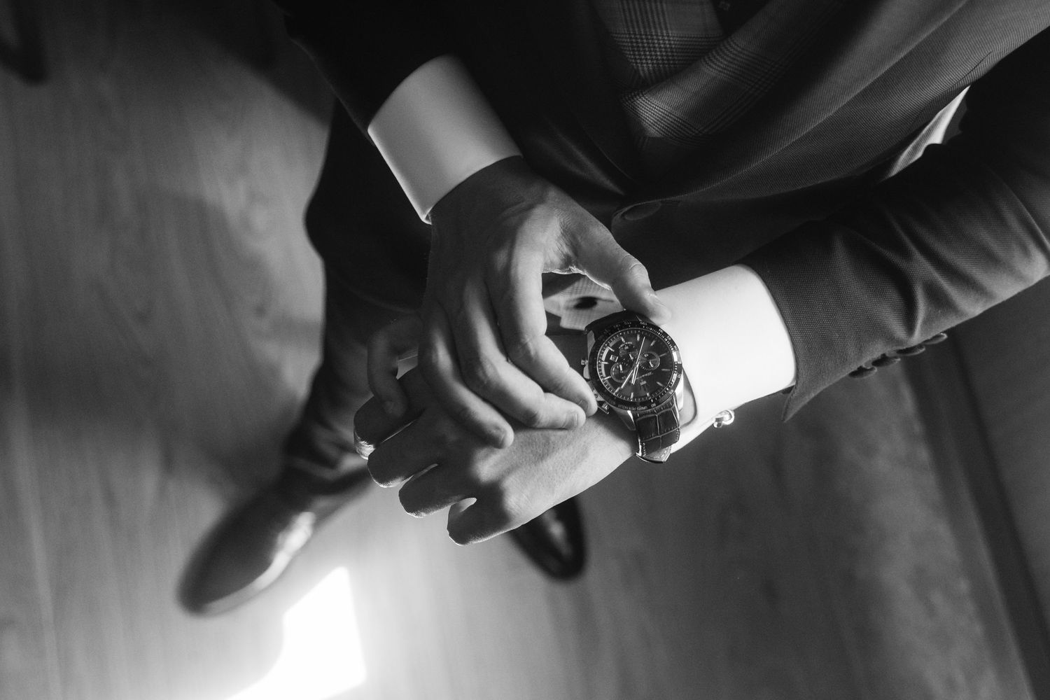 Hands demonstrating step-by-step process of using a watch chronograph function with close-up details.