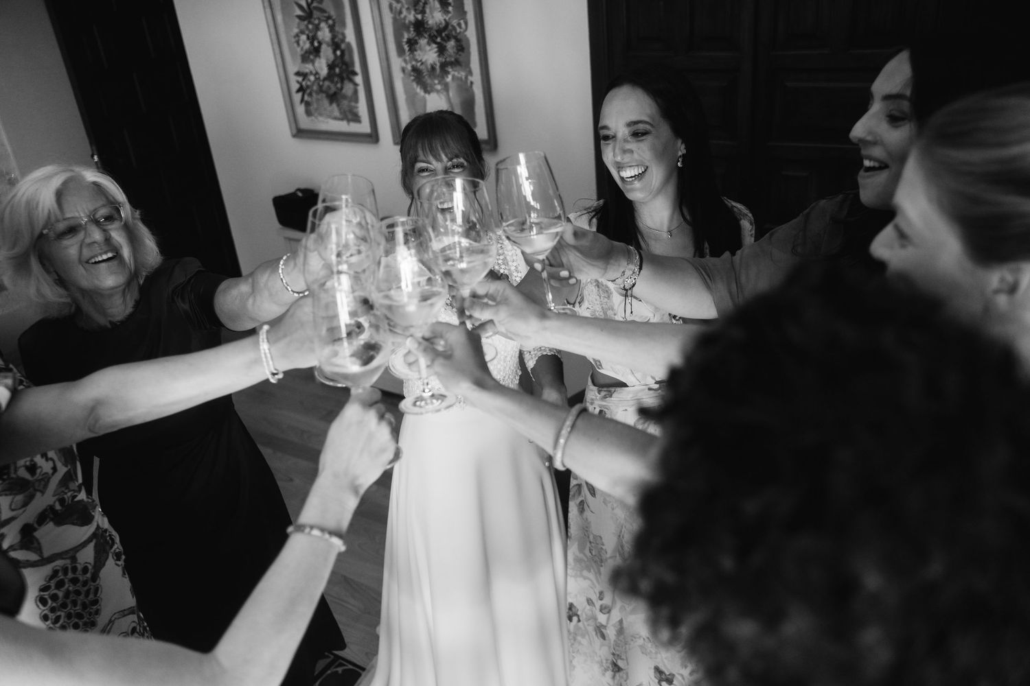 A black and white collage of wedding celebration moments showing people dancing and enjoying festivities.
