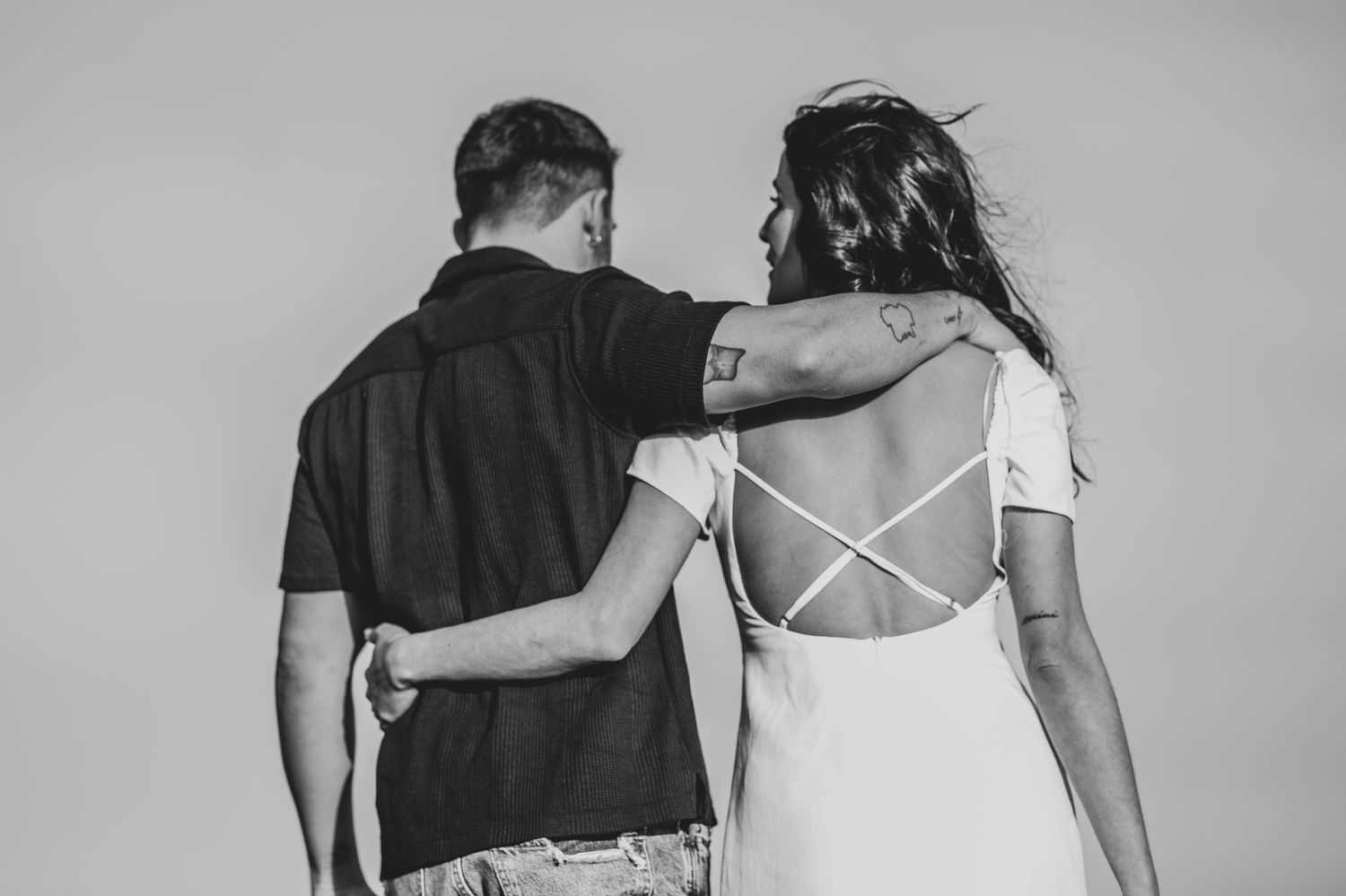 A black and white series of intimate couple portraits showing tender moments and embraces.