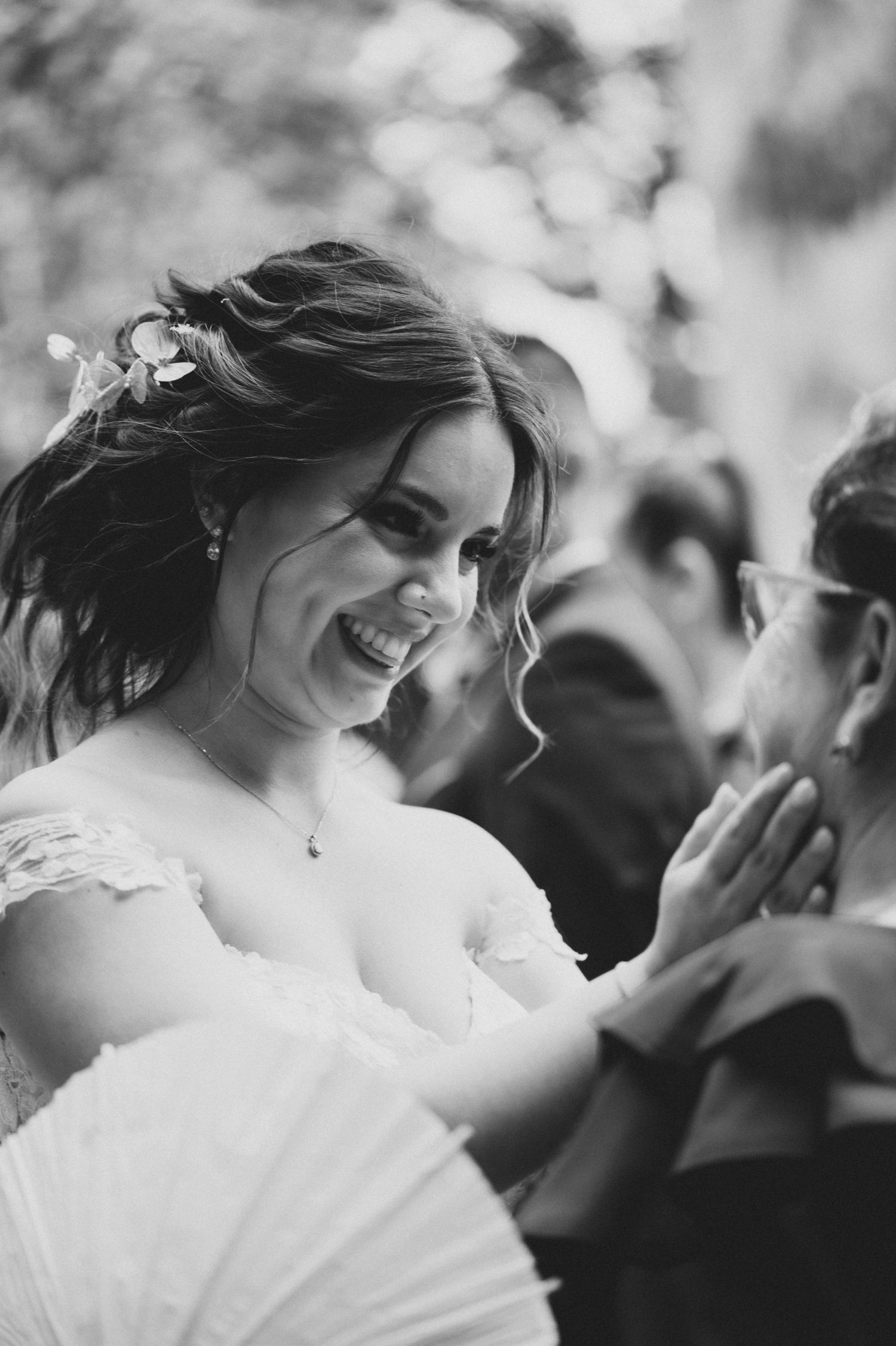 Candid black and white wedding photography captures intimate moments between couples and guests.