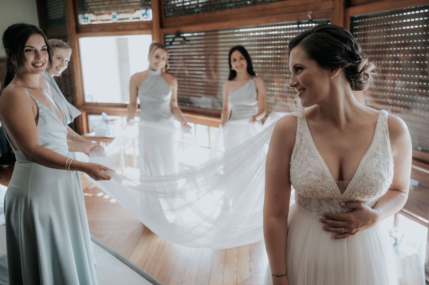 Wedding dress preparations showing flowing white fabric and delicate details in natural window light.