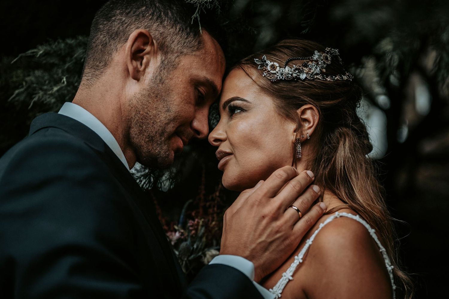 Romantic black and white photo series of newlyweds sharing intimate moments during their wedding photoshoot.