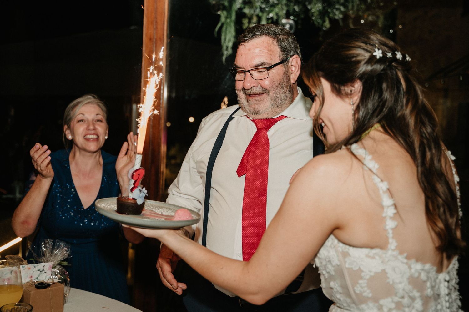 Wedding reception guests dancing and celebrating with energetic moves on the dance floor.