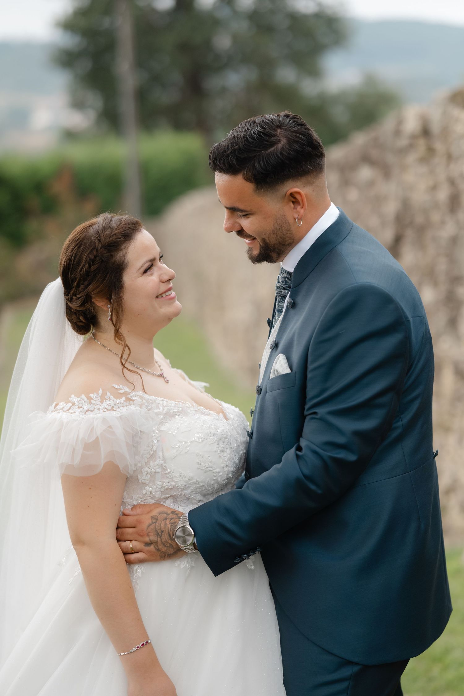 A romantic wedding photo series showing tender moments between newlyweds in an outdoor setting.