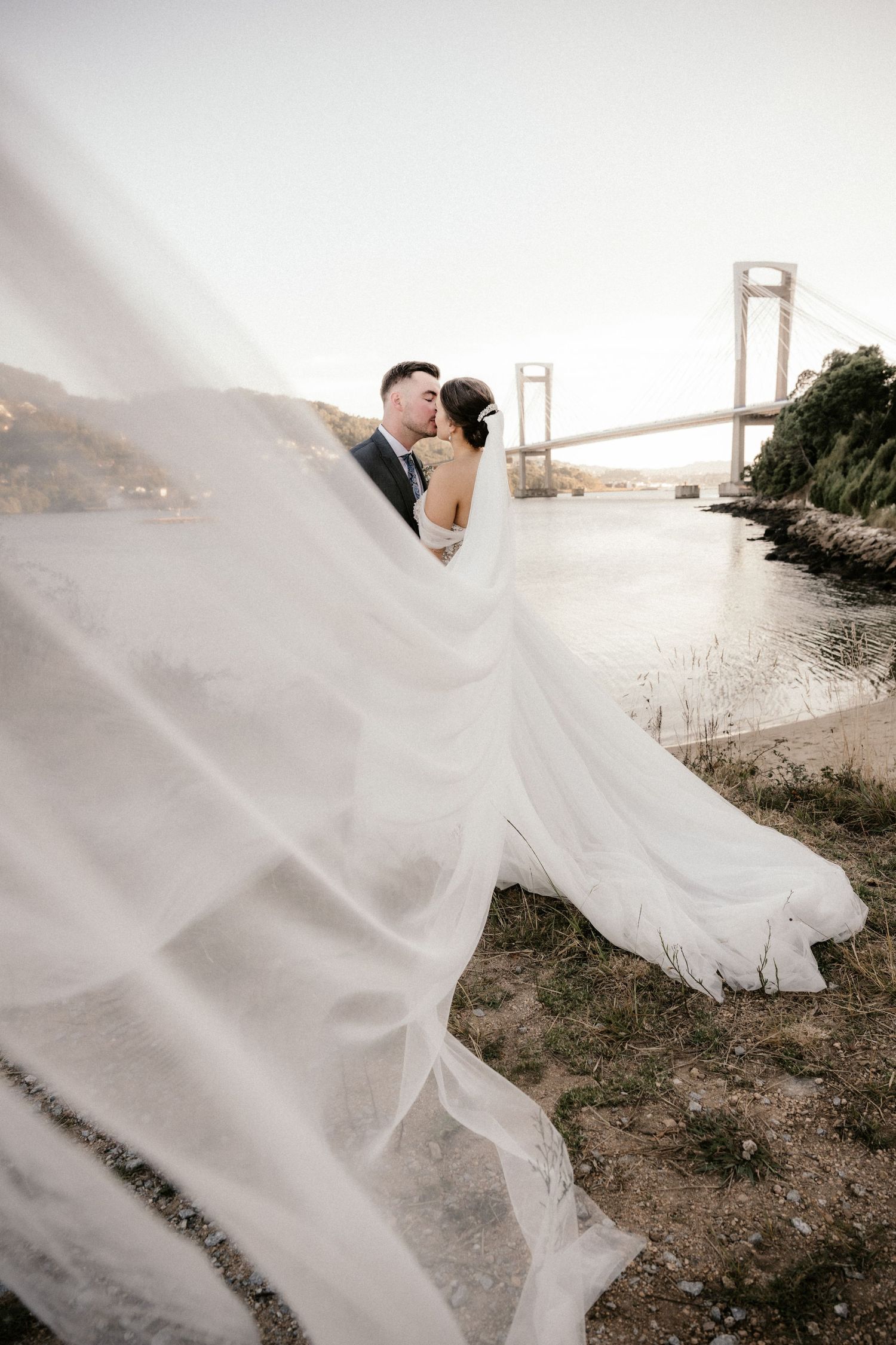 A romantic wedding photo series with flowing white dress against the iconic Golden Gate Bridge in San Francisco.