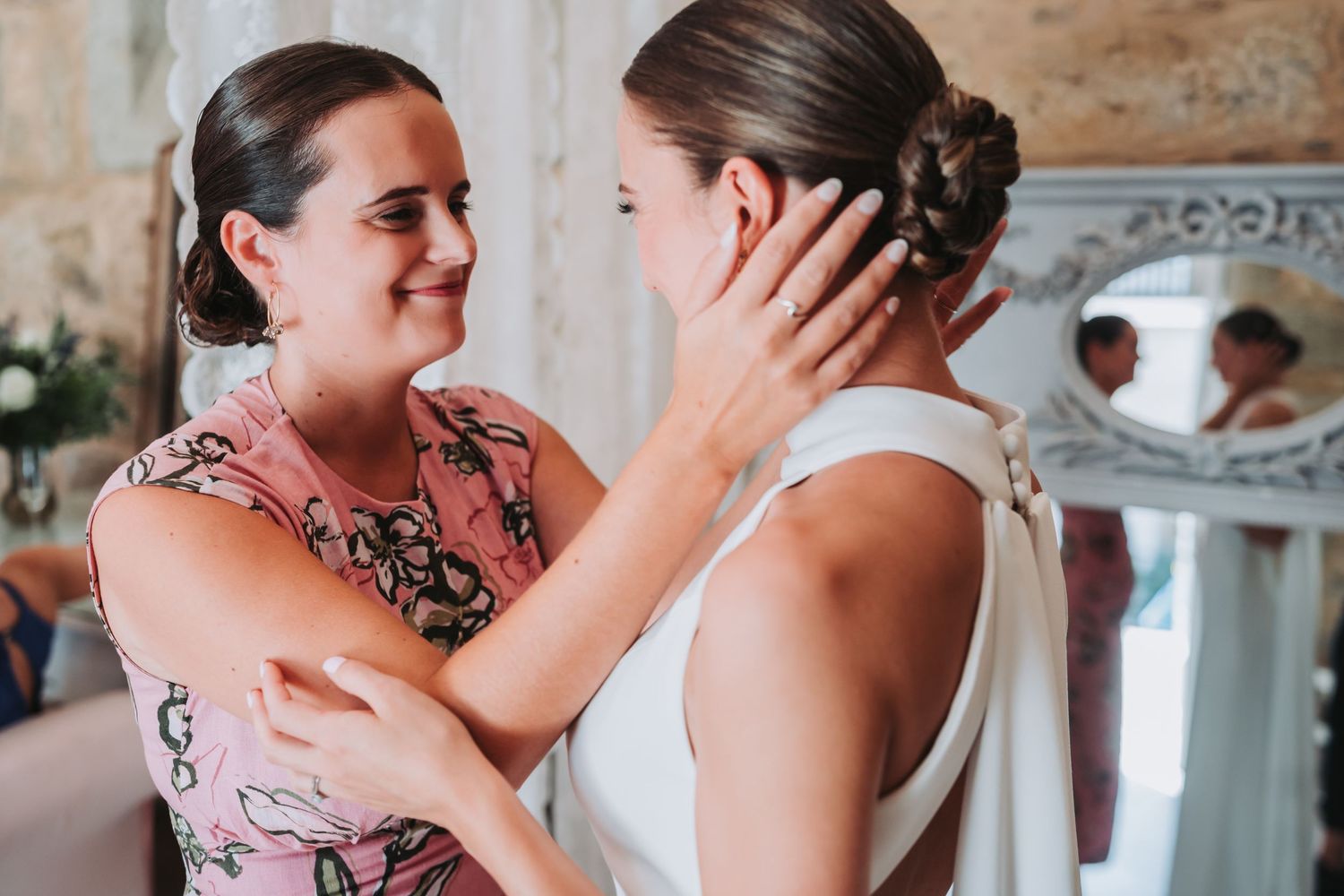 A tender moment shared between two people embracing in formal attire during a wedding celebration.