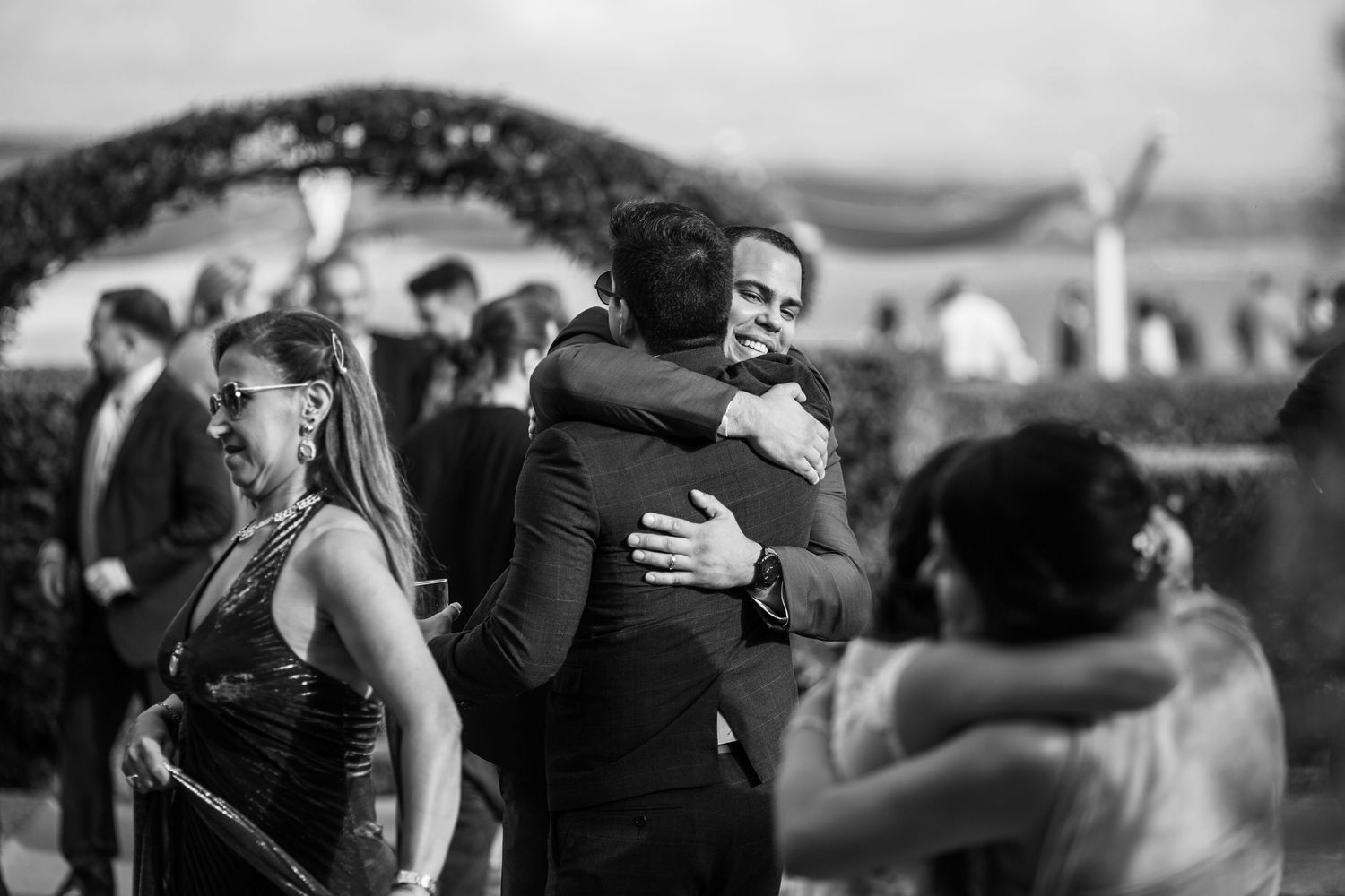 Black and white photo collage showing emotional moments of people embracing and comforting each other.