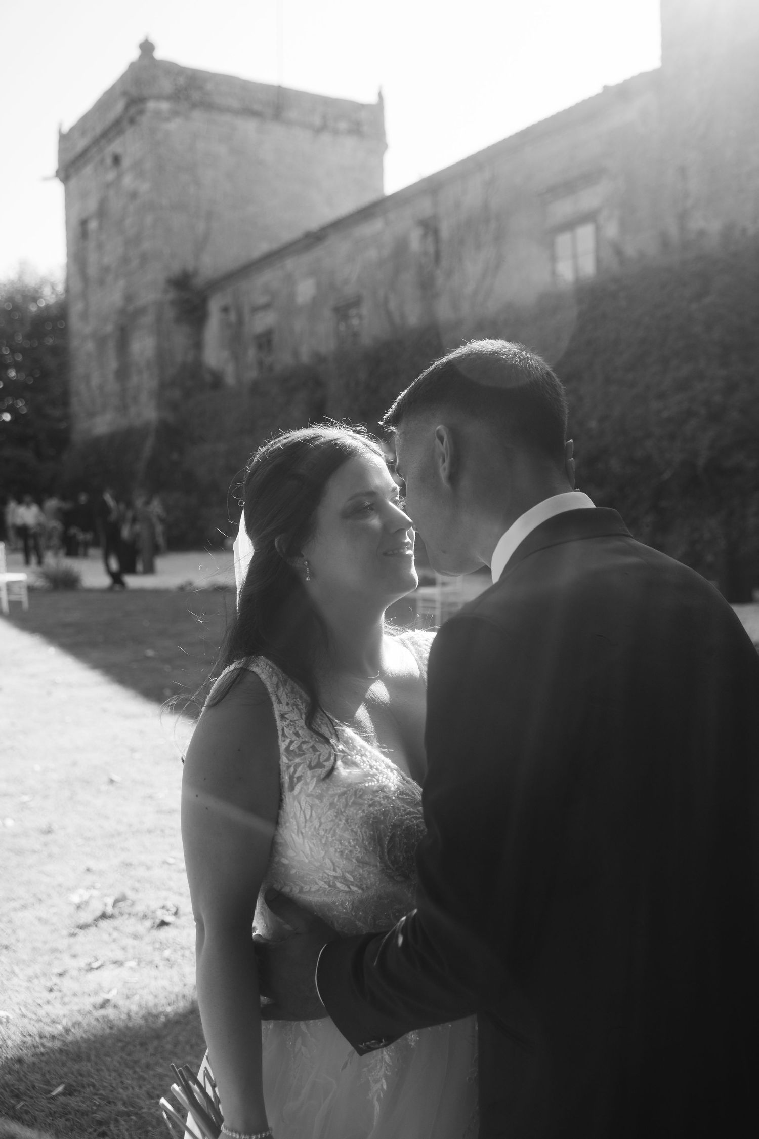 Black and white wedding photography sequence showing tender moments between a couple against historic architecture.