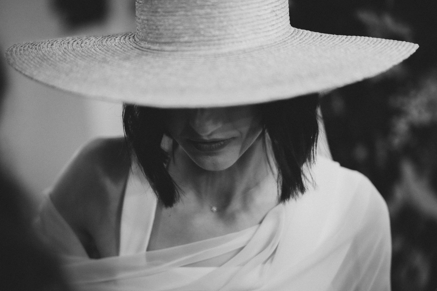 Elegant white sun hats worn at a formal daytime event.
