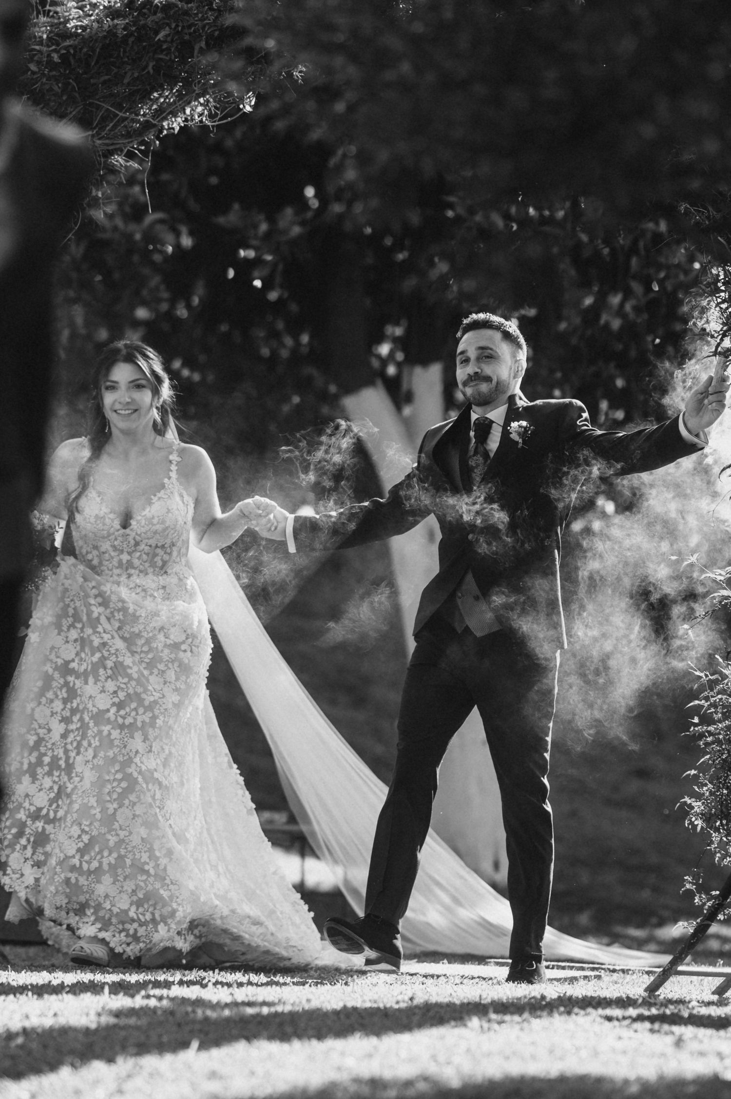 Black and white wedding photo sequence showing couple kicking up snow in winter creating magical powder effects.