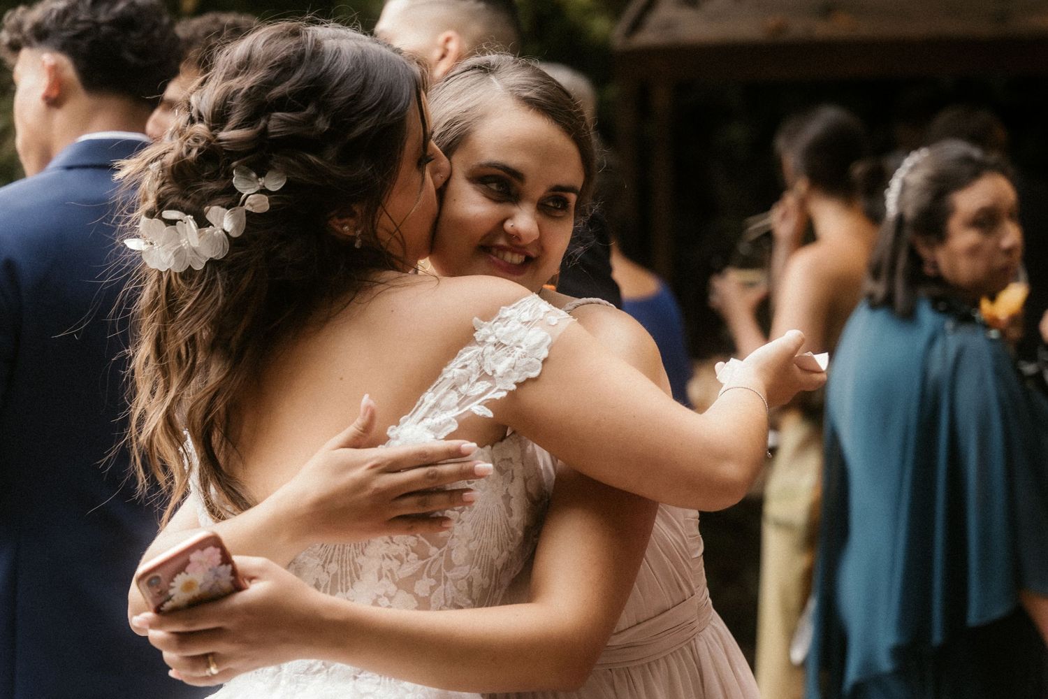 Guests dance and embrace during a joyful celebration at an elegant wedding reception.