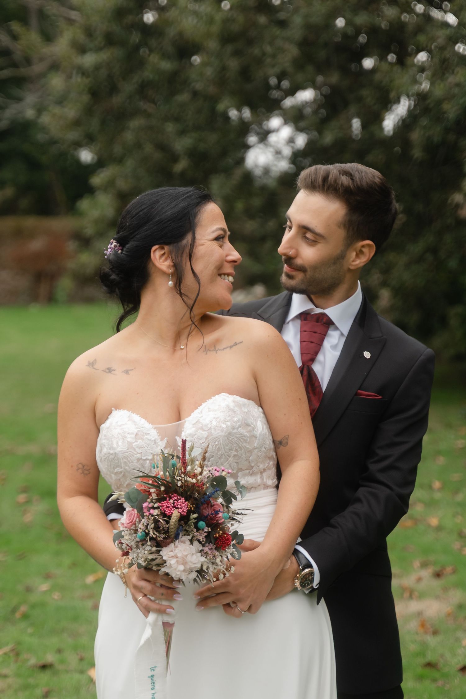 Romantic outdoor wedding photography sequence showing couple embracing with autumn foliage in background.