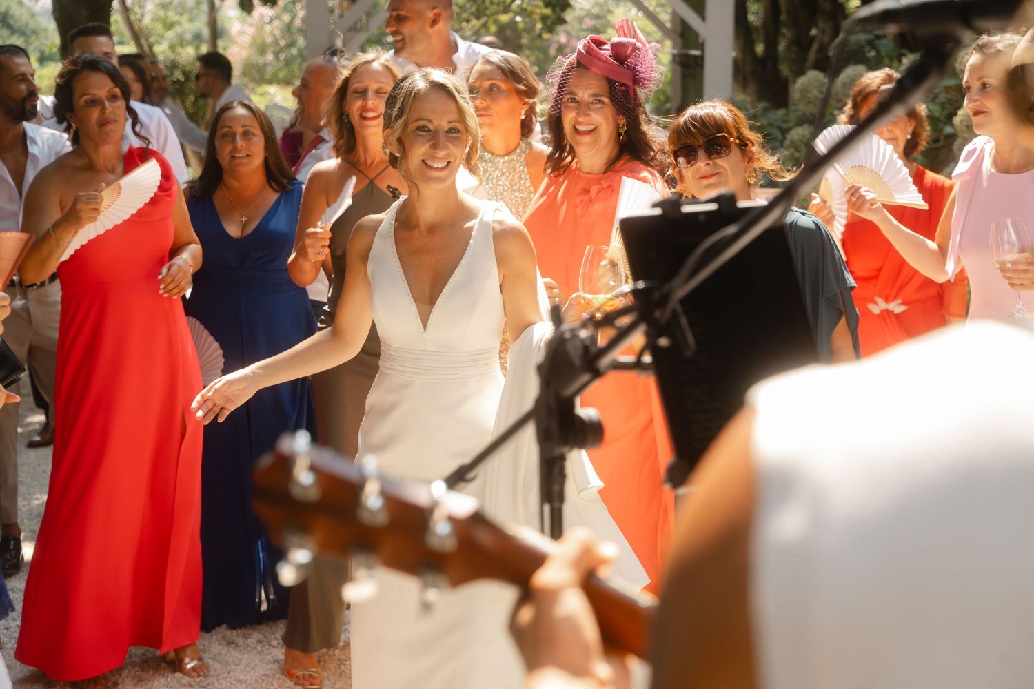 A sequence of candid moments from a wedding celebration showing guests dancing and enjoying themselves outdoors.