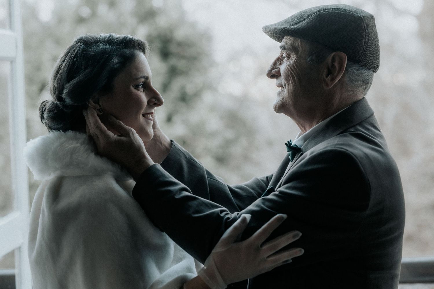 A couple in formal attire dancing together in a romantic, dimly lit setting.
