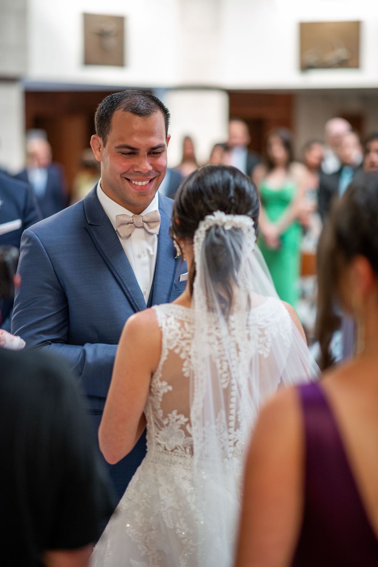 A joyful wedding ceremony taking place inside a bright church sanctuary.