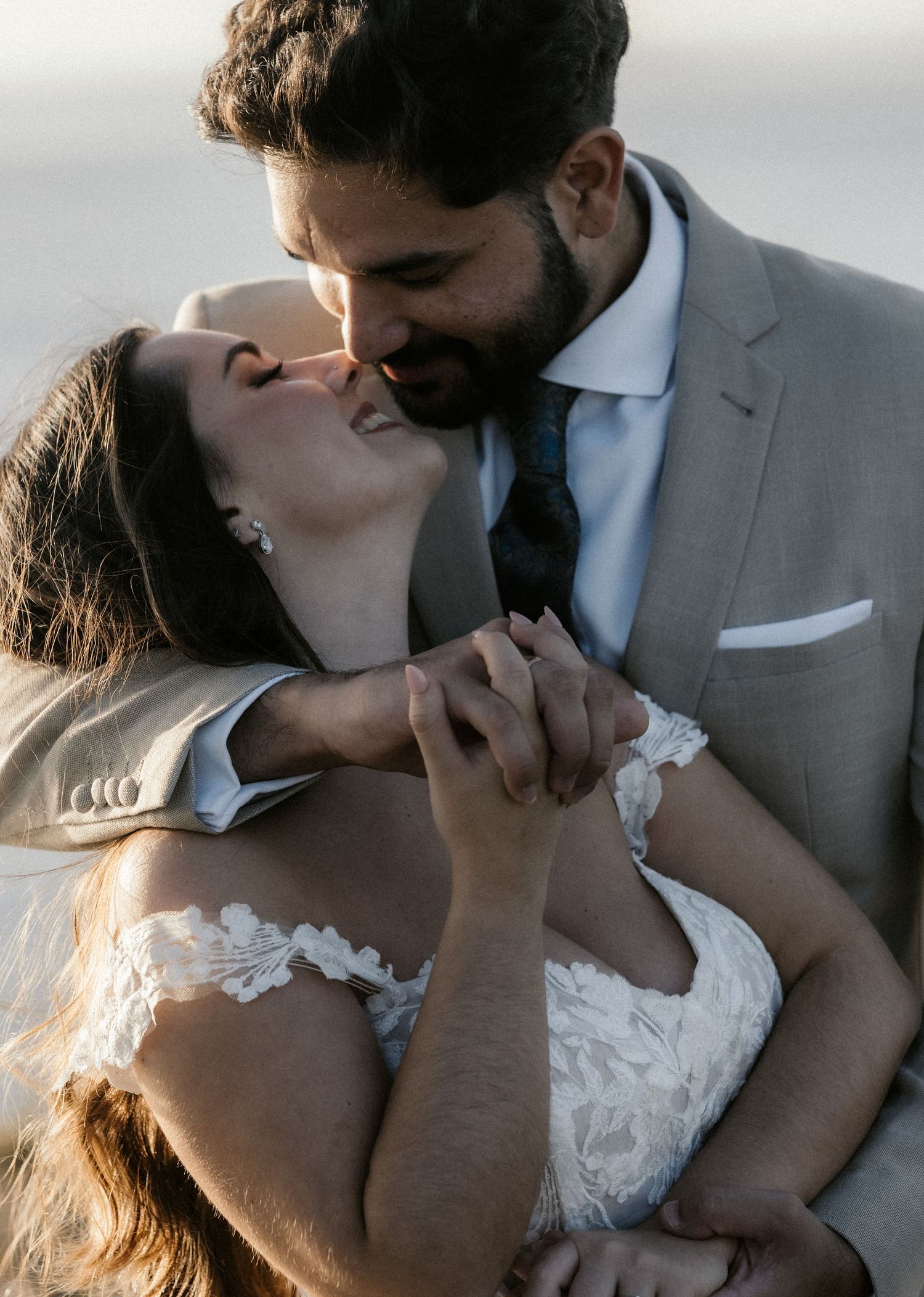 Romantic wedding photography sequence showing tender embraces in soft lighting.