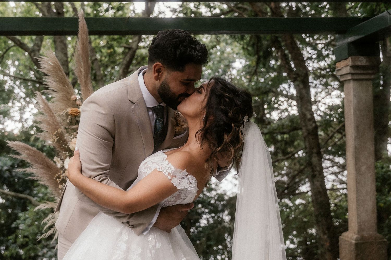 Romantic wedding celebration in a serene forest setting with natural greenery backdrop.