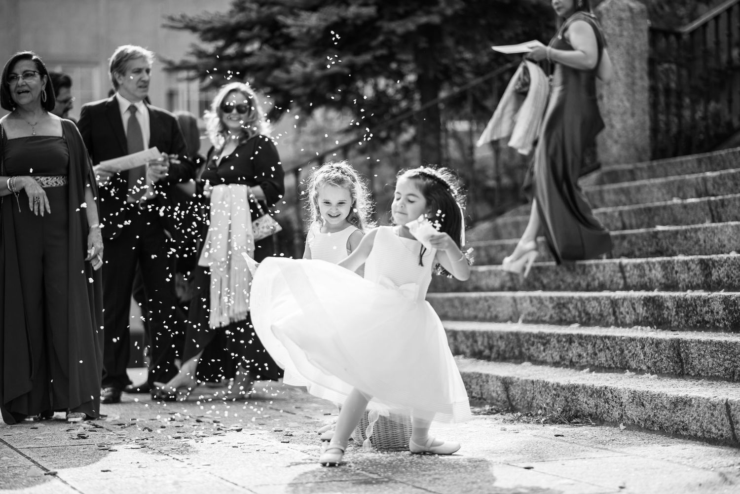 A series of black and white wedding photos showing a joyful celebration with confetti and outdoor scenes.