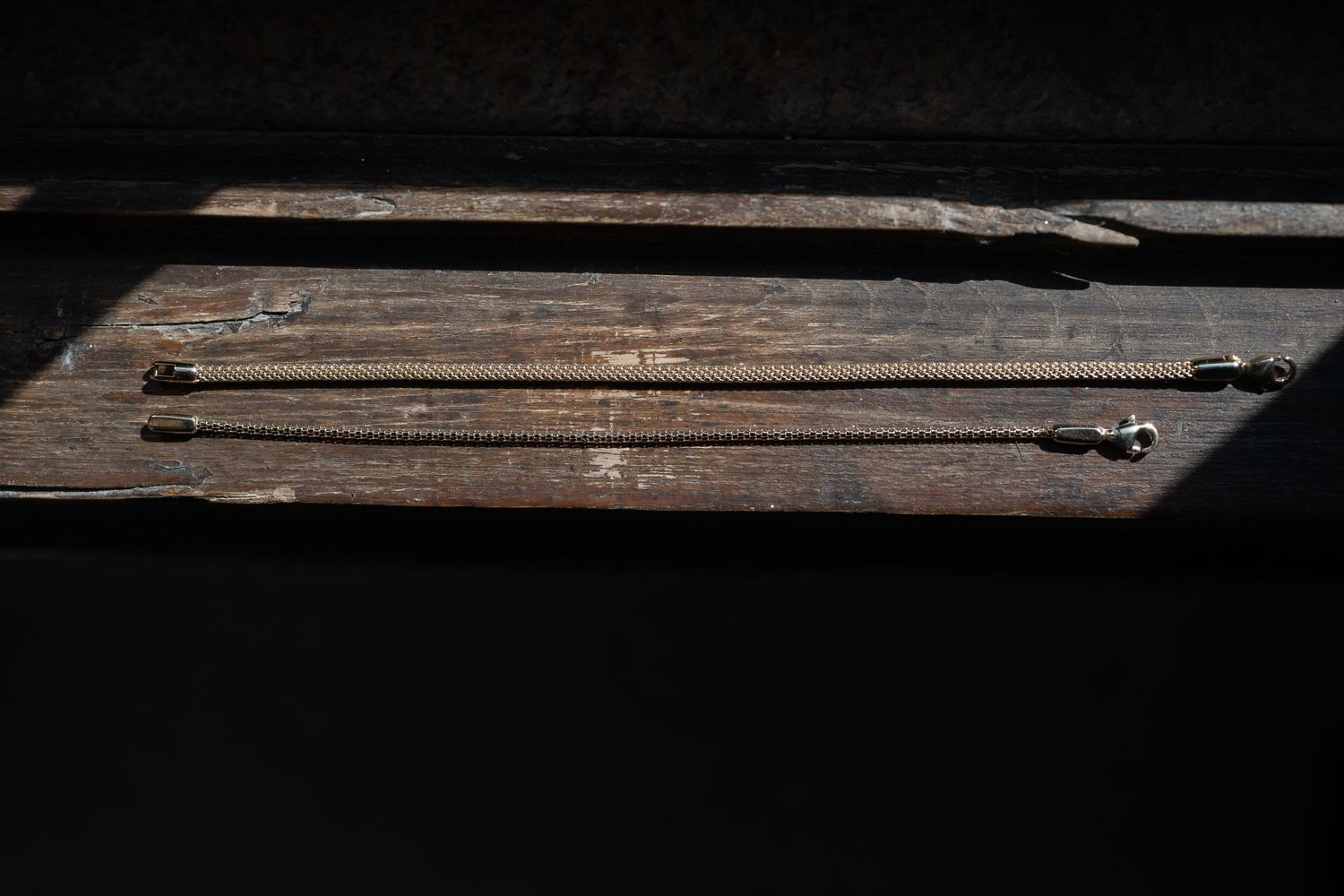 A collection of weathered wooden planks arranged in a row showing natural grain patterns and textures.