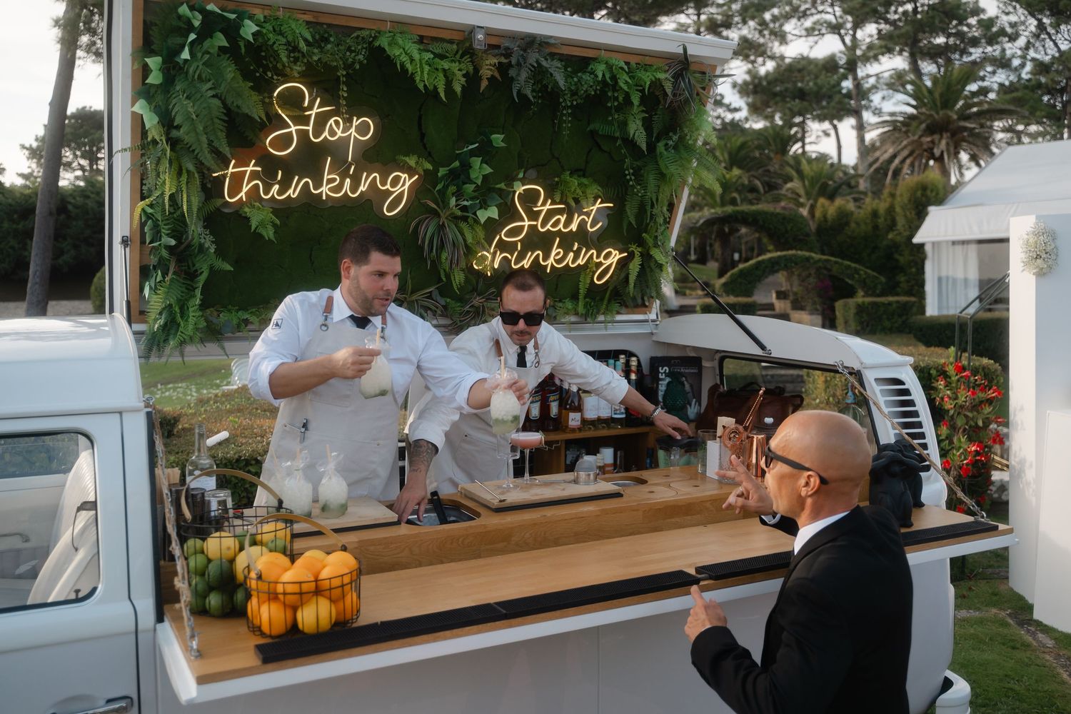 A mobile food service trailer with 'Stop Barking' signage serving customers at an outdoor location.
