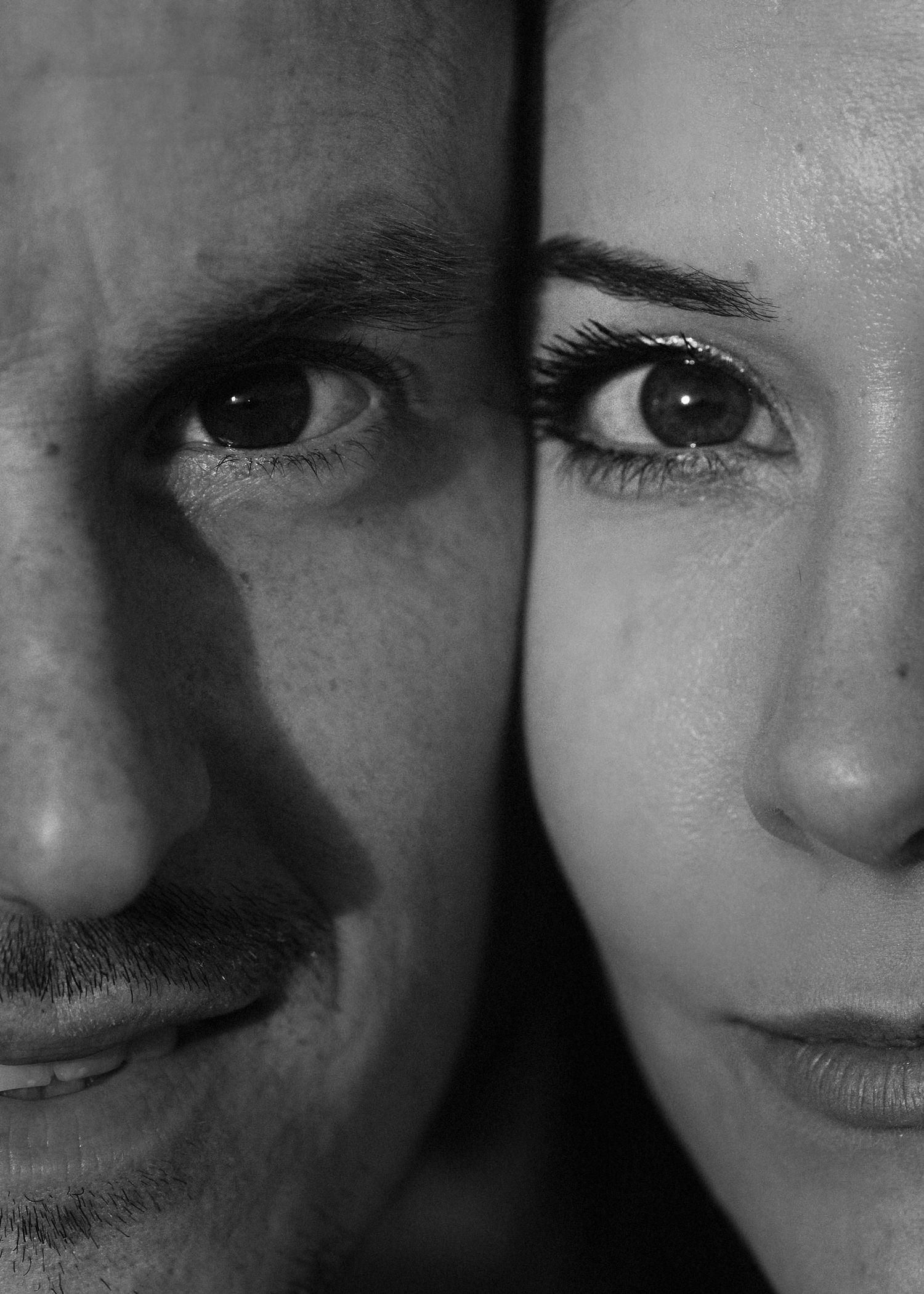 Black and white close-up portrait of a man and woman's faces side by side.
