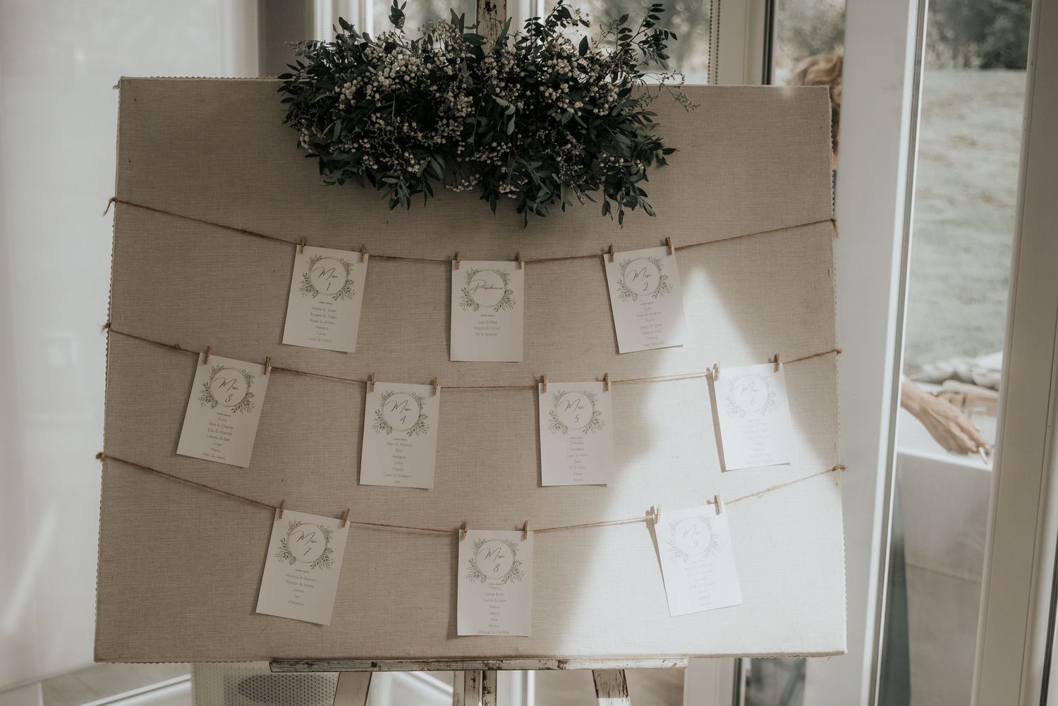 White paper banners and decorative elements hang from ceiling in a minimalist party setting.