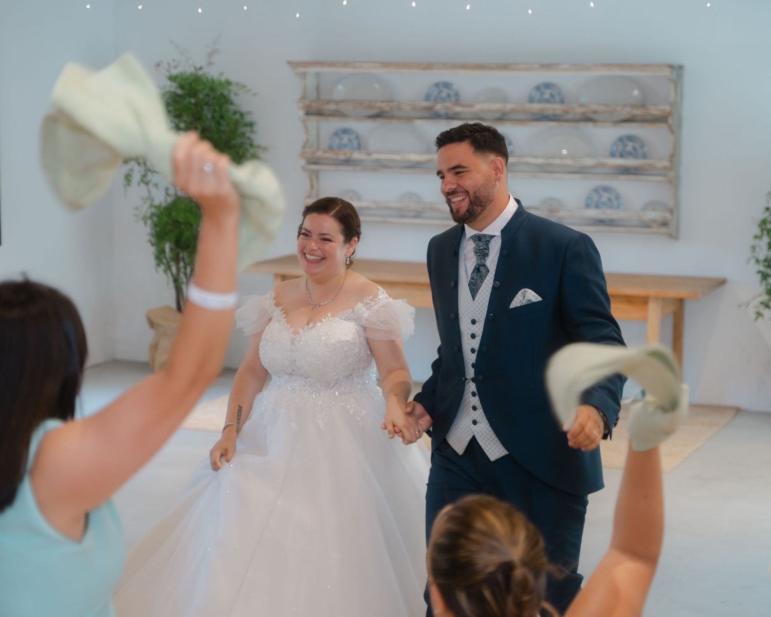 A wedding celebration sequence shows joyful dancing and interaction between guests in formal attire at a reception.
