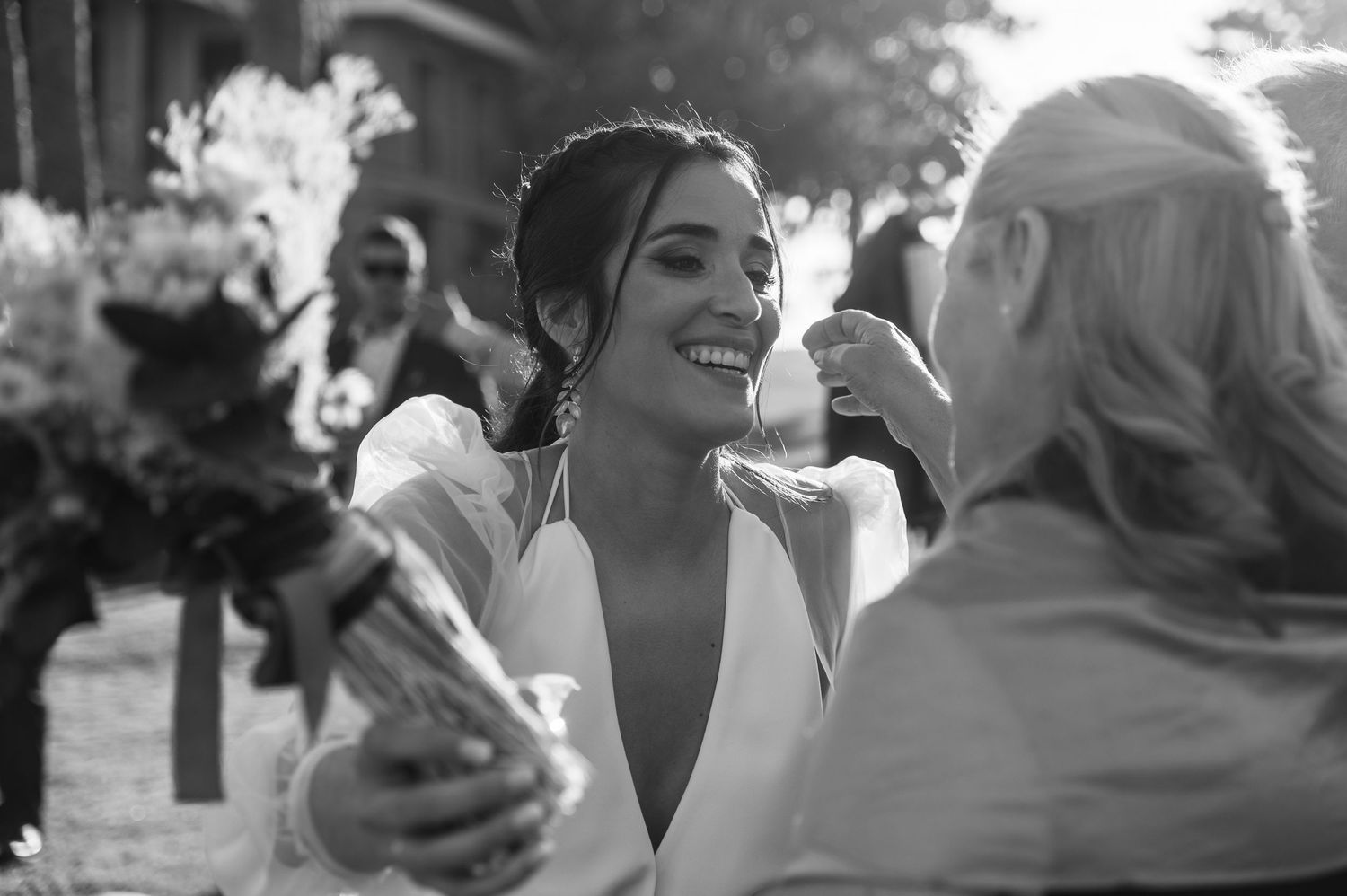 Black and white photo sequence showing candid moments of joyful celebration at an outdoor wedding ceremony.