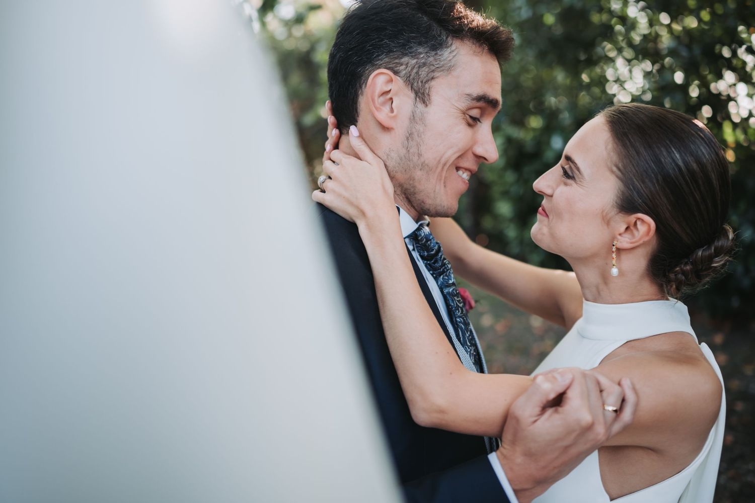 A series of tender moments between a bride and groom during their outdoor wedding ceremony.