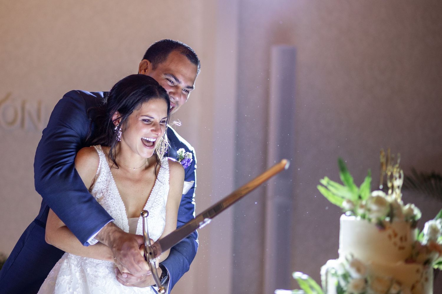 A couple shares a tender moment while holding a microphone during their wedding reception.