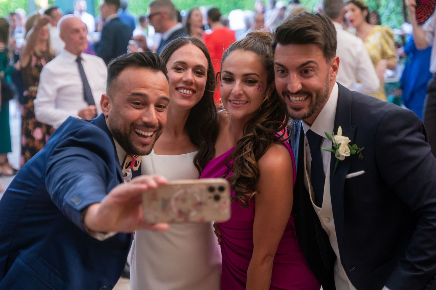 Wedding guests dance and celebrate together during a lively reception party.