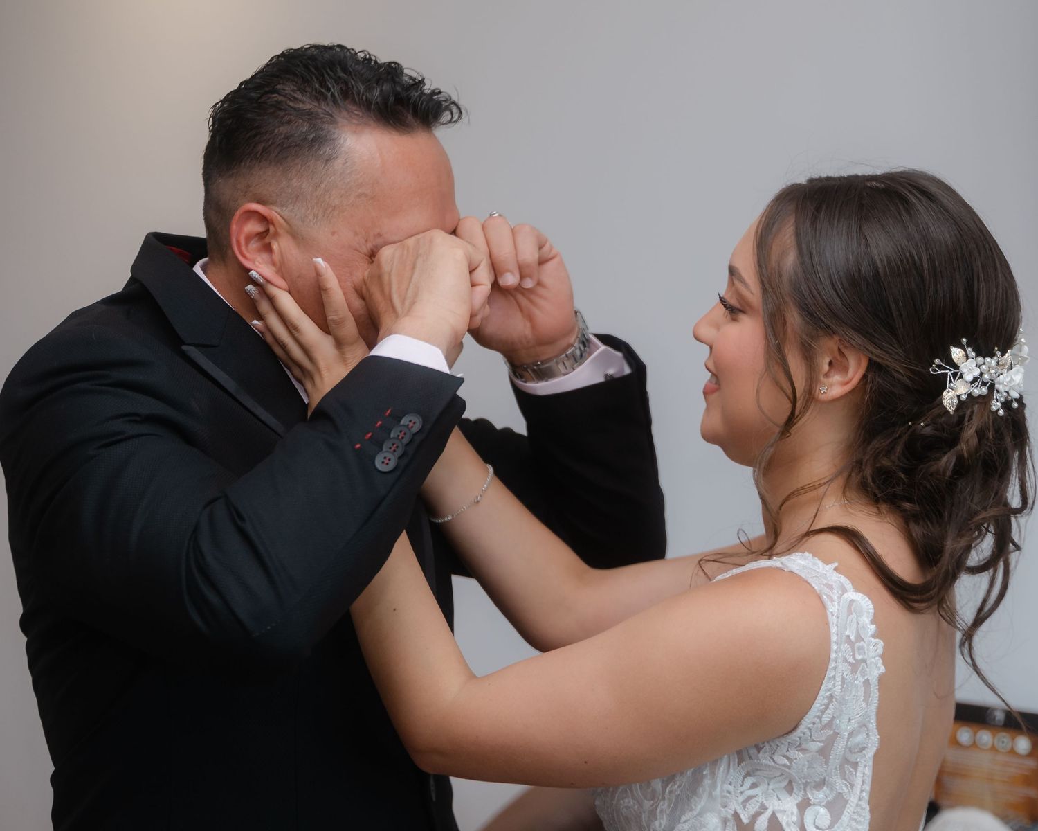 A romantic wedding moment captured as a couple shares an intimate dance in formal attire.