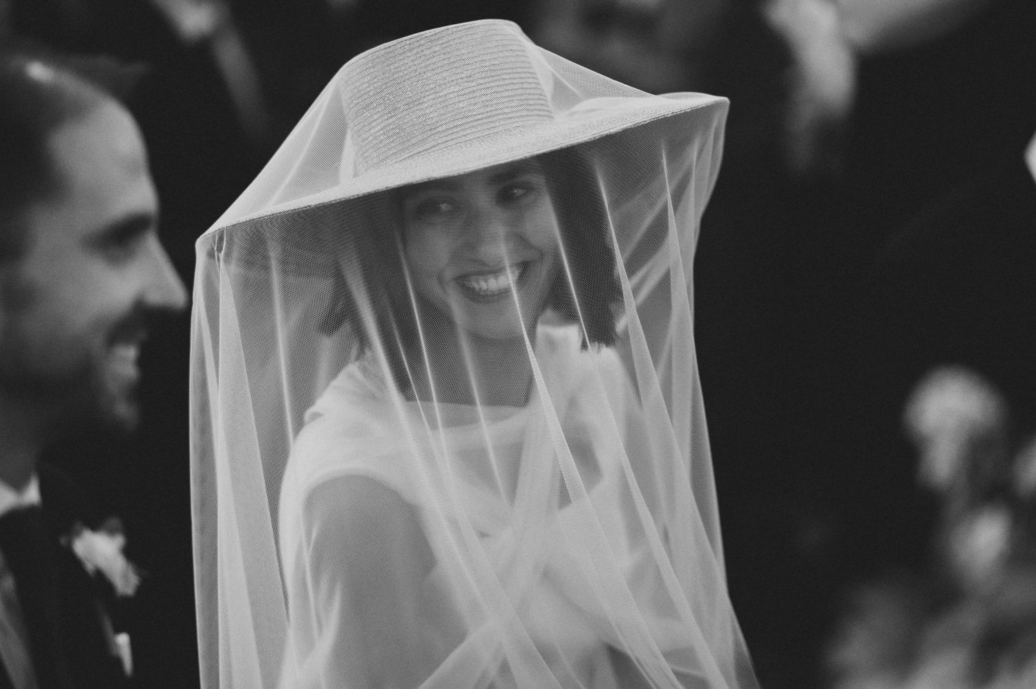 Artistic black and white photo of a bride's veil flowing in multiple frames.