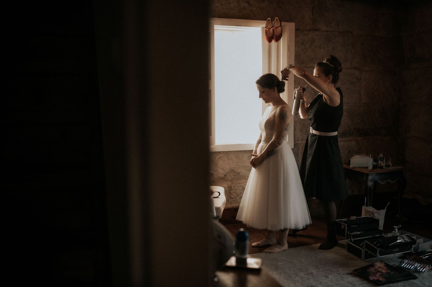 A series of moody, atmospheric wedding preparation photos captured in natural window light with soft shadows.